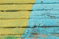 Vintage wood background with peeling yellow and blue paint. Royalty Free Stock Photo