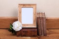 Vintage wood frame with old books on table. Royalty Free Stock Photo