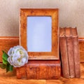 Vintage wood frame with old books on table. Royalty Free Stock Photo