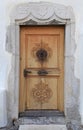 Vintage wood medieval door in rural stone wall house, Switzerlan