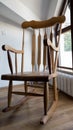 Vintage wood rocking chair on deserted old attic floor. Window and balcony to the street Royalty Free Stock Photo