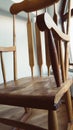 Vintage wood rocking chair on deserted old attic floor. Window and balcony to the street Royalty Free Stock Photo