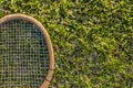 Vintage wood tennis racket on green grass garden Royalty Free Stock Photo