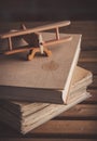Vintage wooden airplane toy and old books Royalty Free Stock Photo