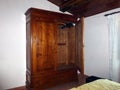 Vintage wooden antique wardrobe in bedroom interior in apartment or hotel with classic design Royalty Free Stock Photo
