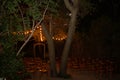 Vintage wooden arch wtih red and pink roses - outdoor wedding ceremony location in coniferous forest wtih classic bentwood chairs