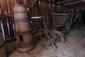 Vintage wooden barn with historical plow, furnace possibly for wood coal production or for blacksmithing.