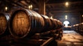 Vintage wooden barrels stored in dark wine cellar, perspective of old brown oak casks in storage of winery. Concept of vineyard,