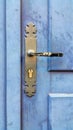 Vintage wooden blue door with metallic handle and keyhole Royalty Free Stock Photo