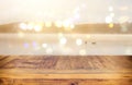 vintage wooden board table in front of abstract photo of misty and foggy lake at morning/evening.