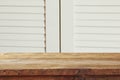 vintage wooden board table in front of old wooden background. Ready for product display montages