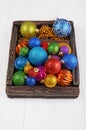 Vintage wooden box with colored bright Christmas tree balls Royalty Free Stock Photo