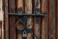 Vintage wooden brown door with old metal lock and ring handle Royalty Free Stock Photo