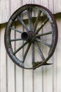 Vintage wooden carriage wheel, wood background. Old wooden carriage wheel hanging on the barn Royalty Free Stock Photo