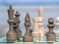 Vintage wooden chess pieces  on the chess  board. Black chess king and bishop. Close-up Royalty Free Stock Photo