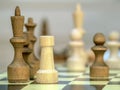 Vintage wooden chess pieces  on the chess  board. Black king and whtite rook. Close-up Royalty Free Stock Photo