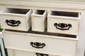 Vintage wooden chest of drawers with black metal handles open Royalty Free Stock Photo