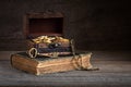 Vintage wooden chest full of gold coins, treasure key, pirate treasure concept