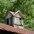 Vintage wooden shuttered cupola on barn roof Royalty Free Stock Photo