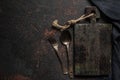 Vintage wooden cutting board, cutlery and kitchen towel on dark concrete background. top view with copy space Royalty Free Stock Photo