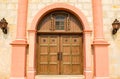 Vintage wooden door with carriage lamps and columns at the Santa Barbara mission Royalty Free Stock Photo