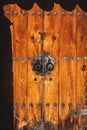 Vintage wooden door with intricate iron details including rivets and knobs. Royalty Free Stock Photo