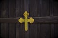 Vintage wooden door with metallic golden colored Christian Cross in Christian Church Royalty Free Stock Photo