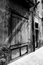 Vintage wooden door spotlit by sunlight, black and