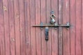 Vintage wooden garage door wth padlock and old metal hasp