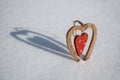 Vintage wooden heart on snow