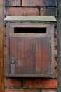 Vintage Wooden Mailbox on the Brick Wall