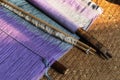 Vintage wooden parts of the loom with purple woven cloth on background, Inle lake, Myanmar