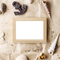 Vintage wooden photo frame on craft paper with sand and sea shells mock up Royalty Free Stock Photo