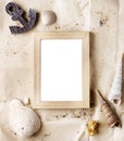 Vintage wooden photo frame on craft paper with sand and sea shells mock up Royalty Free Stock Photo