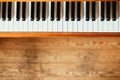 Vintage wooden piano. Keys in the foreground, wooden floor with text space in the blurry background