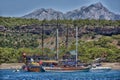 Vintage wooden pirate schooner in the open ocean against the background of the sea horizon. Tourist cruises in the Mediterranean