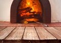 Vintage wooden planks over blurred traditional stove for baking pizza