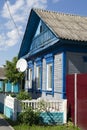 Vintage wooden rural house with ornamental windows, frames in Belarus. Traditional national folk style in architecture