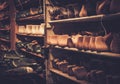 Vintage wooden shoe lasts in a row on the old shelves.