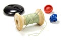 Vintage wooden spool of green thread, needle and buttons on white background Royalty Free Stock Photo