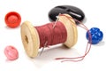 Vintage wooden spool of red thread, needle and buttons on white background Royalty Free Stock Photo