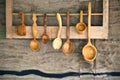 Vintage wooden spoons hang on rustic wooden wall Royalty Free Stock Photo