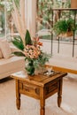 Vintage wooden table in a cozy and inviting home interior decorated with vibrant plants