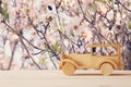 Vintage wooden toy car over wooden table. Nostalgia and simplicity concept. Royalty Free Stock Photo