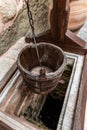 Vintage wooden well bucket and stone well for water usage in Meteora Monasteries, Greece Royalty Free Stock Photo