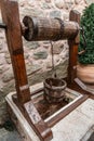 Vintage wooden well bucket and stone well for water usage in Meteora Monasteries, Greece Royalty Free Stock Photo