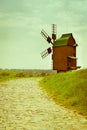 Vintage wooden windmill on stone road Royalty Free Stock Photo
