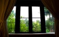 Vintage wooden window frames look out to see the trees in the garden look relaxed Royalty Free Stock Photo