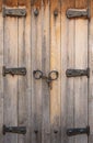 Vintage wooden window shutters with rusty iron hinges and padlock on chain in Nesebar. Closed rustic wooden shutters Royalty Free Stock Photo