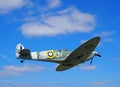 Vintage world war 2 Mark Vb spitfire in flight againt a blue sky with clouds